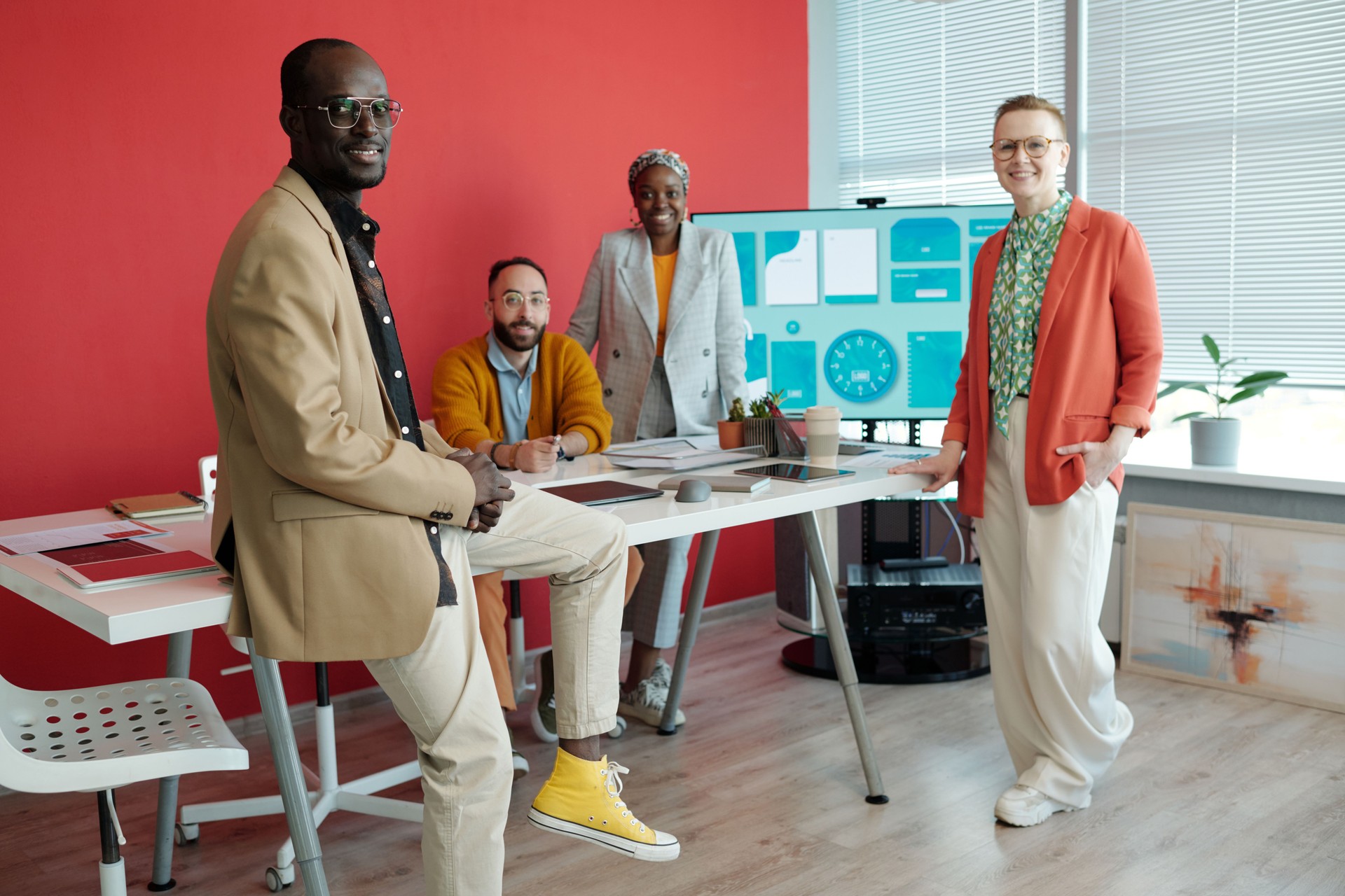 Diverse Team Posing in Modern Office with Digital Screen