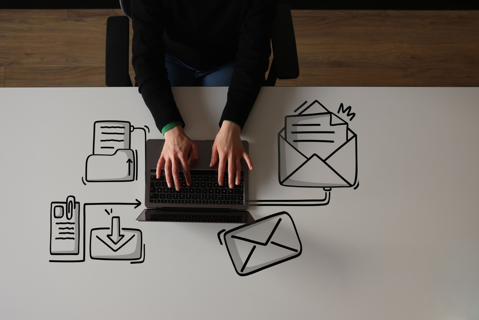 Woman using laptop with envelope icons
